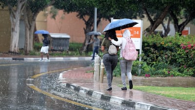 Umbrellas out during heavy rain in Dubai. Pawan Singh / The National