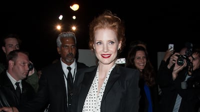Jessica Chastain, in a monochrome polka dot dress and blazer, arrives at the Saint Laurent spring/summer 2013 show during Paris Fashion Week on October 1, 2012. Getty Images