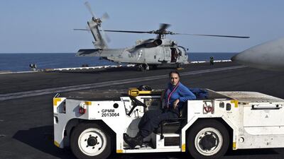 A tractor driver, wearing a blue shirt.