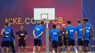 Barcelona coach Ernesto Valverde and his staff pass on instructions to the players. EPA