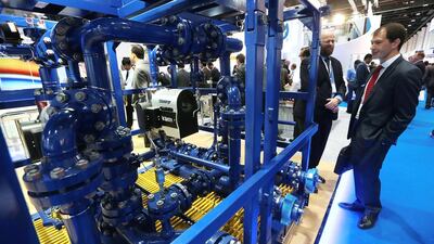 Delegates take a look at the Schlumberger display at Adipec 2015. Christopher Pike / The National