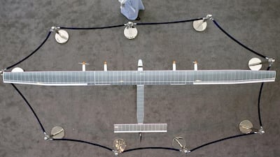A visitor looks at a solar-powered plane on display at the World Future Energy Summit. Yoshua Arias / EPA