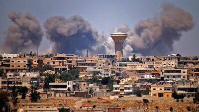 Smoke rises above rebel-held areas of the city of Deraa during reported air strikes by Syrian regime forces in 2018. Since hostilities resumed in July, civilians have witnessed intense fighting and indiscriminate shelling. AFP