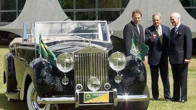 Rolls-Royce president Ralph Robbins, British Prime Minister Tony Blair and Brazilian President Fernando Henrique Cardoso stand next to the Rolls-Royce Silver Wraith in July 2001 in Brasilia