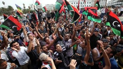 Residents celebrate in Tripoli Thursday after hearing that former Libyan leader Muammar Gaddafi was killed in Sirte.