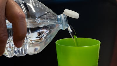 In the UAE, plastic bottle tops could soon be tethered to bottles to reduce pollution. AFP