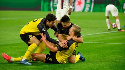 Dortmund forward Erling Haaland is congratulated by teammates Giovanni Reyna and Raphael Guerreiro after giving his side the lead against PSG. AFP