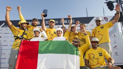 Abu Dhabi Ocean Racing crew pose with the UAE flag on Saturday after arriving in Abu Dhabi to complete the Volvo Ocean Race's second leg. Ian Roman / Abu Dhabi Ocean Racing
