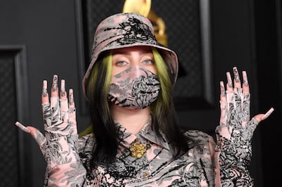 US singer-songwriter Billie Eilish attends the 63rd Annual Grammy Awards in matching suit, bucket hat, mask and finger nails. Kevin Mazur.Getty