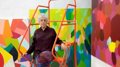 Samia Halaby in her studio in front of her work. Even in her eighties the artist continues to experiment with technique. Courtesy Samia Halaby