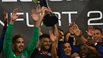 Players of Paris Saint-Germain celebrate with the trophy after winning the Trophee des Champions ‘super cup’ match between PSG and Lyon in Klagenfurt, Austria, on August 6, 2016. Samuel Kubani / AFP