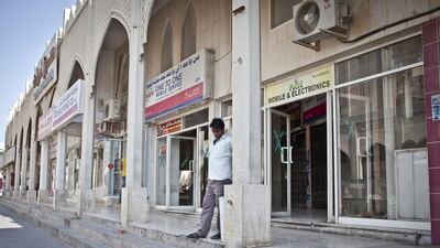 A man stands outside a shop. Three decades ago, Msheirib and its South Asian merchants were the commercial centre of a sleepier Doha. Some of the first international hotel chains in the capital opened here, and residents used to shop at furniture shops and mini-shopping centres here that have been overtaken by newly built and glitzy mega-malls springing up elsewhere in the city.