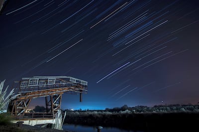 An overlay image of 148 photographs shows the Quadrantids meteor shower over the village of Hinojedo, in Cantabria, northern Spain, early on January 3, 2022. EPA