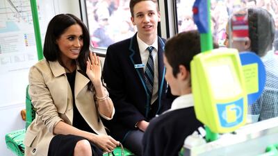 Meghan chats to students on the tram. AP Photo