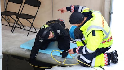Divers from Oslo Fire Brigade took part in a search under ice on a small lake near the home of billionaire Tom Hagen's home. Reuters