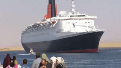 The Queen Elizabeth 2 passes through the Suez Canal on the way to its new home in Dubai.