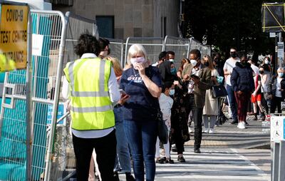 Britons queue outside a coronavirus testing site in Bolton. Reuters