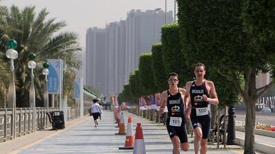 Two runners do their final loop in the Elite Male Short course in Abu Dhabi International Triathlon 2014 at Corniche beach in Abu Dhabi. Ravindranath K / The National