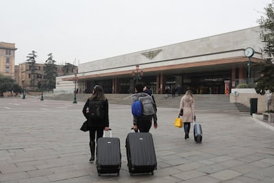 Tourists are seen walking with their luggage towards the Venice Santa Lucia train station in an attempt to leave the city on March 10, 2020 in Venice, Italy. Getty