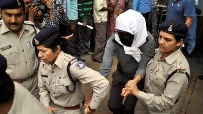 A Swiss rape victim is escorted by policewomen for a medical examination at a hospital at Gwalior in the Indian state of Madhya Pradesh.