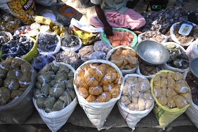 Pulses packed in single-use plastic bags at a market stall in Chennai on Friday. Some experts expect problems from unprepared manufacturers and consumers unwilling to pay more. AFP