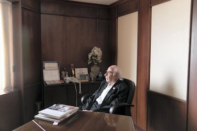 Maganmal Pancholia, 94, looks out the window of his office. Reem Mohammed / The National