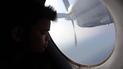 A man looks out a window during search and rescue (SAR) operations for a missing Malaysian Airlines flight, off Vietnam’s coast. Luong Thai Linh / EPA March 11