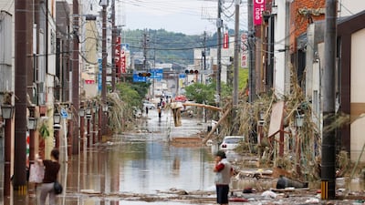 A street is flooded following a heavy rain in Hitoyoshi, Kumamoto prefecture. Kyodo News via AP