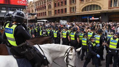 Protesters march through the streets during an anti-lockdown rally in Melbourne on Saturday. Photo: AFP