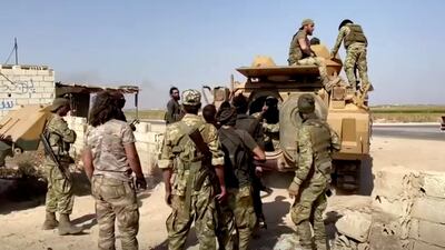 Syrian rebel soldiers leave their base near Tal Abyad, Syria, in this screen grab taken from video. Reuters