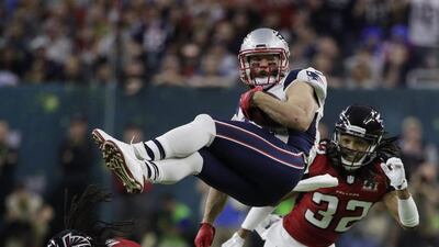 New England Patriots’ Julian Edelman is upended by Atlanta Falcons’ Philip Wheeler, bottom, during the first half of the NFL Super Bowl in Houston. Jae C Hong / AP