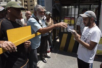 People wait for free soup in Caracas, Venezuela. EPA