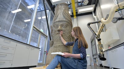 A British Museum stone conservator prepares a head of an Assyrian winged bull, which originated from the palace of Ashurbanipal's father, Esarhaddon, at Nimrud in 670 BC. Getty Images