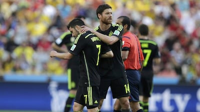 Xabi Alonso reacts during Spain's 3-0 win over Australia on Monday with David Villa at the 2014 World Cup in Curitiba, Brazil. Henry Romero / Reuters / June 23, 2014