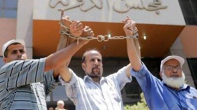 Egyptian protesters demonstrate in front the State Council ahead of an anticipated Administrative Court ruling on the panel writing the new constitution in Cairo, Egypt, Thursday, July 19, 2012. Arabic reads "State Council." (AP Photo/Amr Nabil) *** Local Caption *** Mideast Egypt .JPEG-0048c.jpg