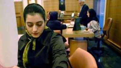 A woman admires a Rolex watch at a shopping centre in Tehran.