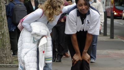 A distraught commuter is consoled near Euston station