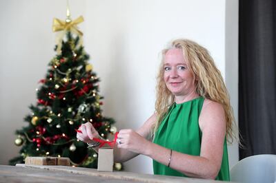 Heidi-Jane Hill wrapping Christmas gift at her villa in Al Barsha in Dubai. Pawan Singh / The National