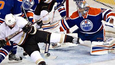 Anaheim's Matt Beleskey is stopped by Edmonton Oilers goalie Nikolai Khabibulin.