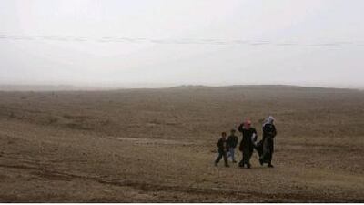 Children walk through a field in Hasika, a drought-ridden province in the east, last winter. Phil Sands / The National
