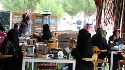 Men and women sit at cafe in Riyadh. Reuters
