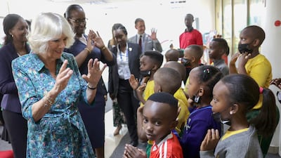 Camilla, Duchess of Cornwall, communicates with young school pupils who have impaired hearing using sign language, at Kigali Public Library. Getty Images