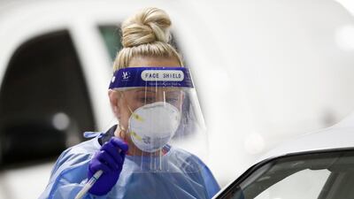 A medical practitioner performs a coronavirus test in the carpark of Bunnings in West Footscray in Melbourne, Australia. Getty