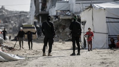 Armed militants, from the Al Qassam Brigades, during a search for the bodies of the remaining Israeli hostages in the Jabalia refugee camp in northern Gaza. Getty Images