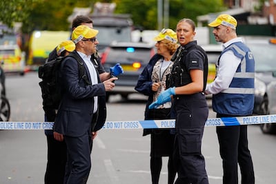 Synagogue security support volunteers talk to police at the cordon. PA Wire