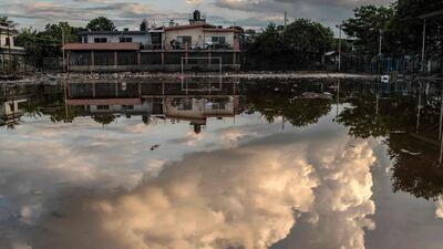 A cloudy sky reflected in a puddle on a football field, after heavy rain fell in Poza Rica, Mexico. AFP