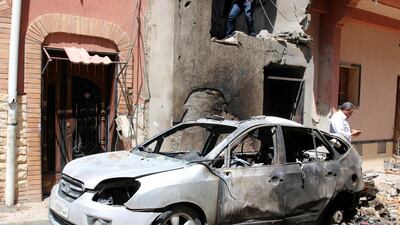 People inspect the damage after overnight shelling on the southern district of Abu Salim, Tripoli, Libya. EPA
