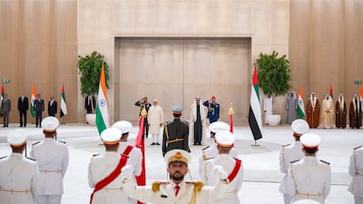 Sheikh Mohamed and Mr Modi stand for the national anthem