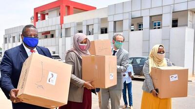 In this photo provided by United Nations-African Union Mission in Darfur, the joint UN-African Union envoy for Darfur, Jeremiah Mamabolo, left, stands at Khartoum airport, in Sudan, on June 23, 2020. Sudan could receive an additional $1.5 bn in aid following a current debt relief plan and the end of international sanctions. AP Photo
