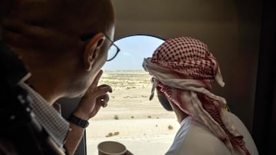 People look out a window onboard an Etihad Rail train at Dubai's Yalayis station, during the inaugural passenger service connecting from Abu Dhabi's Mohamed Bin Zayed City station to Dubai. AFP